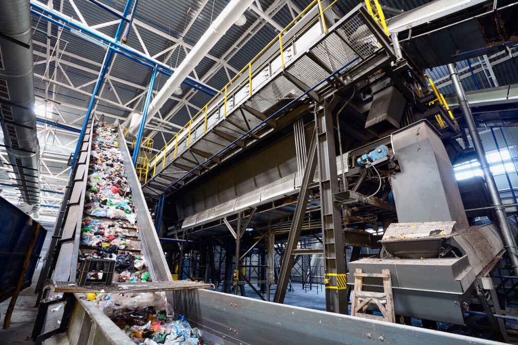 Wide-angle view of a recycling plant where advanced processes transform waste into sustainable materials using drum filters or trommel sieves.