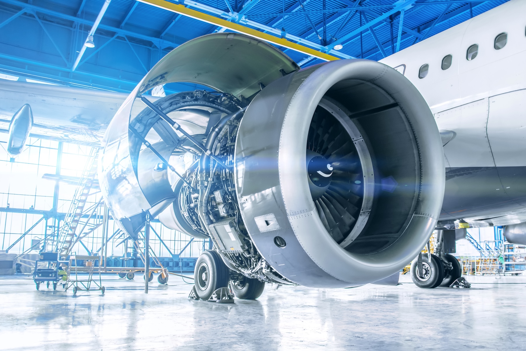 Industrial theme: Repair and maintenance of an aircraft engine on the wing, showcasing composite materials for durability and performance.