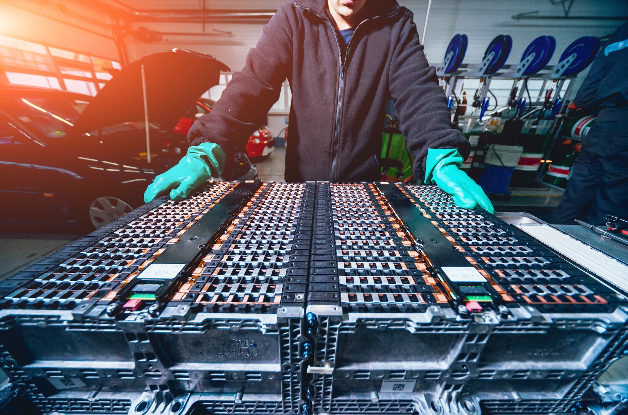 Battery recycling in action: Disassembling an electric vehicle battery for sustainable reuse and energy storage.