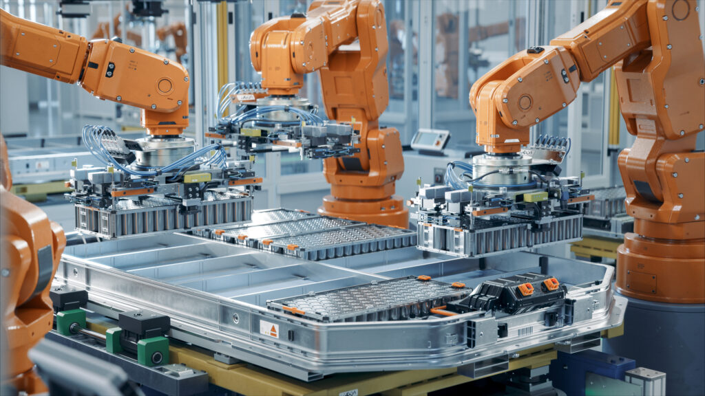 A modern EV battery pack production line equipped with advanced orange robotic arms. Inside a bright, smart automotive factory, a row of automated robots assembles next-generation battery packs, including solid-state batteries, for electric vehicles.